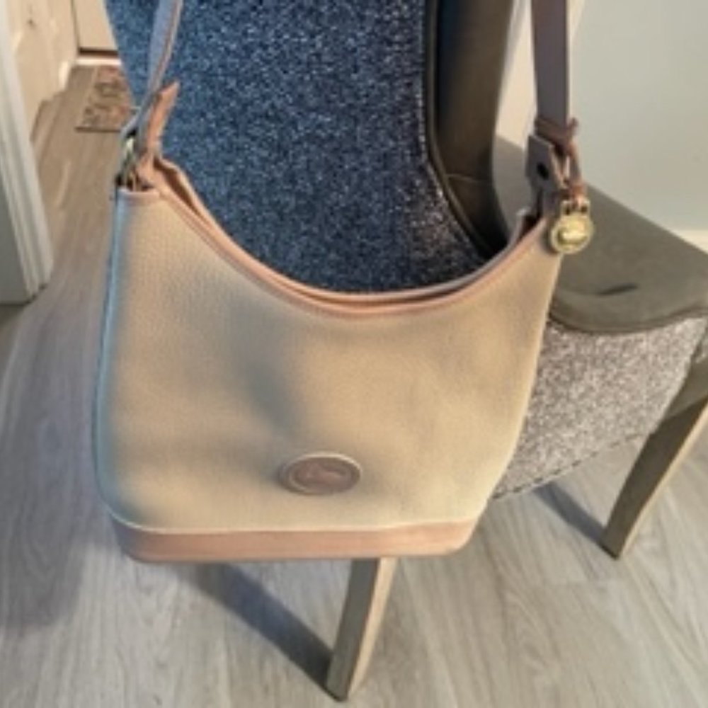 Dooney and Bourke Shoulder leather hand bag with matching wallet.